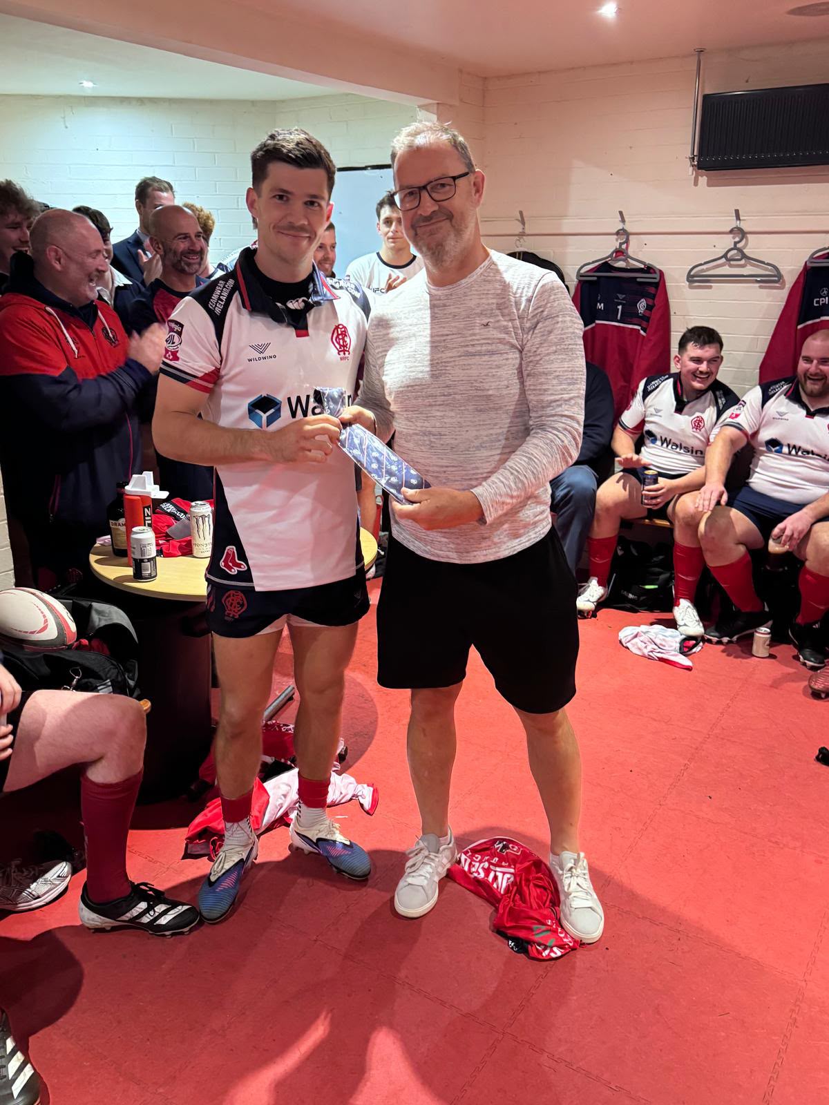 Malone debutant receiving his AIL cap tie in the changing room